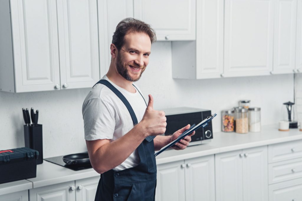 smiling handsome adult bearded repairman holding c