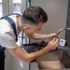 man-spinning-faucet-aerator-on-spout-pipe.jpg