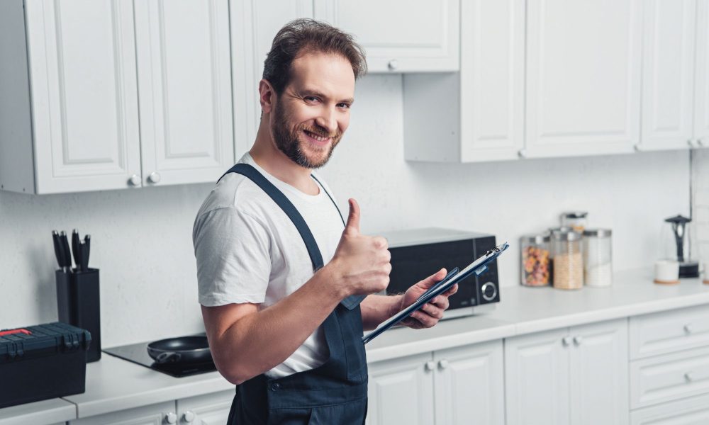 smiling handsome adult bearded repairman holding c